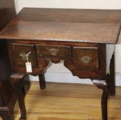 An early18th century oak lowboy, fitted three short drawers with shaped apron, on cabriole legs W.