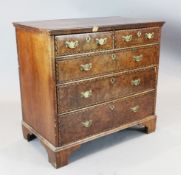 An early 18th century burr walnut chest, of two short and three graduated long drawers, with ebony