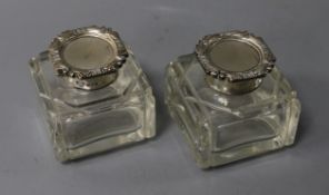 A pair of George V silver topped ink bottles.