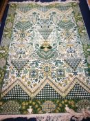 A Tunisian cream ground rug W.240cm x 170cm
