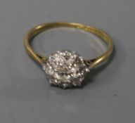 An early 20th century 18ct gold and platinum diamond cluster ring, size L.