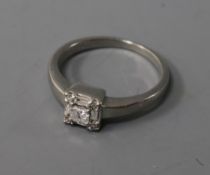 A modern platinum and diamond set square cluster ring, size I.