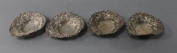 A pair of Victorian embossed silver bon bon dishes and two other dishes.