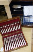 A quantity of cased flatware, including a set of twelve pairs of silver-bladed mother of pearl-