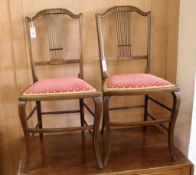 An Edwardian mahogany tub shaped armchair and a pair of inlaid bedroom chairs