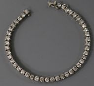 An 18ct white gold and diamond line bracelet, set with forty four round cut stones, 18cm.