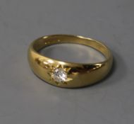 An 18ct gold and gypsy set solitaire diamond ring, size T.