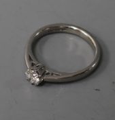 An 18ct white gold and solitaire diamond ring, size O.