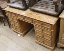 A pine pedestal desk, fitted nine small drawers W.122cm
