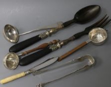 A pair of white metal mounted salad servers, two silver tea strainers, a pair of sugar tongs, a