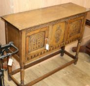 A reproduction oak low cupboard W.107cm