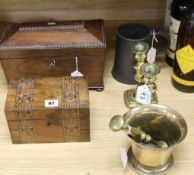 An 18th century bell metal pestle and mortar, a pair of brass candlesticks, two tea caddies and a