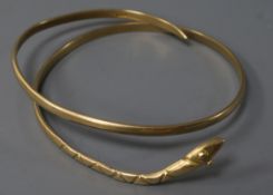 A Middle Eastern yellow metal serpent bangle, 35.9 grams.
