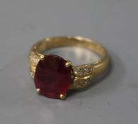 A modern 14ct gold ruby and diamond set dress ring, size O.