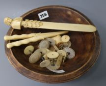 A carved ivory page turner, sewing tools, glove stretchers