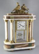 A 1930's polychrome onyx portico mantel clock, surmounted by ormolu doves, the 3.5 inch Arabic