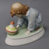 A Zsolnay ceramic model of a young child with a spinning top height 12cm