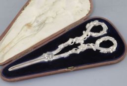 A cased pair of Victorian cast silver grape shears by Francis Higgins II, with reeded vineous