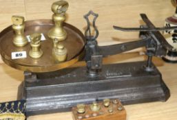 A set of Victorian black painted cast iron scales, with brass pans and weights
