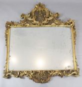A late Victorian giltwood and gesso wall mirror, with ornate pierced scroll flower and dragon