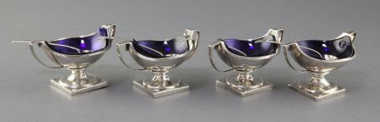 A matched set of four (two pairs) George III silver two handled circular pedestal salts, Peter,