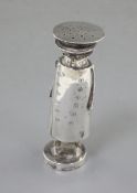 An Edwardian novelty silver pepperette in the form of a motorist, Saunders & Shepherd, Chester,