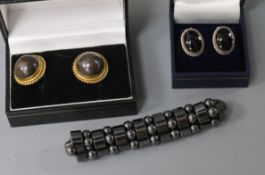 A pair of 18ct gold and mabe pearl earclips, a pair of silver and cabochon earclips and a hematite