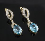 A pair of modern 18ct gold, blue zircon and diamond drop earrings, set with oval cut zircons, 36mm.