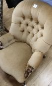 A Victorian mahogany-framed low armchair with scrolled terminals, deep-buttoned beige upholstery