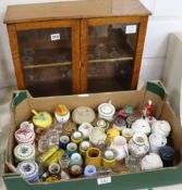 A collection of Colmans mustard and other lidded ceramic mustard pots contained in a small 2 door
