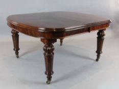 A Victorian mahogany extending dining table, with rounded ends and three spare leaves, Extends to