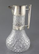 A late Victorian silver mounted cut glass claret jug by Hukin & Heath, in the manner of