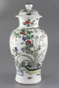A Chinese famille verte vase and cover, late 19th century, finely painted with a rockwork garden