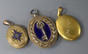 An early 20th century yellow metal oval locket and two other lockets including silver gilt and