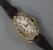 A French 1920's/1930's 18ct white gold, diamond and gem set oval cocktail watch.
