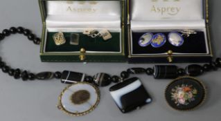 Two cased pairs of Asprey & Co silver cufflinks including a parcel gilt pair and an enamelled