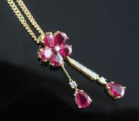 A modern 18ct gold, ruby and diamond set double drop pendant, of flower head design, on an Italian