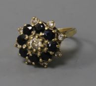 A yellow metal sapphire and diamond cluster ring, size P.