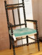 A Victorian child's ebonised bobbin turned elbow chair W.36cm