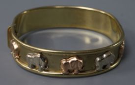 An Italian 9ct gold hinged bangle decorated with elephants, 24.7 grams.