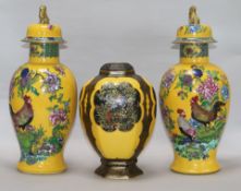 A pair of Carlton ware yellow ground vases and covers and a similar jar