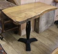 An oak top rustic table with a cast iron base W.99cm