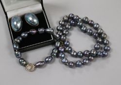 A single strand Tahitian? cultured pearl necklace, a similar bracelet and a pair of 9ct gold mounted