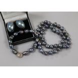 A single strand Tahitian? cultured pearl necklace, a similar bracelet and a pair of 9ct gold mounted