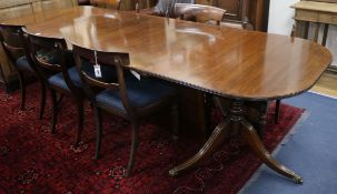 A Regency style banded mahogany two pillar extending dining table W.274cm