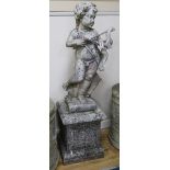A weathered reconstituted stone garden figure of Cupid with bow and quiver of arrows, on square