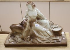 A large ceramic model of a lady and a deer, signed Polbert