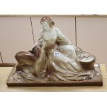 A large ceramic model of a lady and a deer, signed Polbert