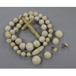 An ivory bead necklace, a carved cross and three pairs of earrings.