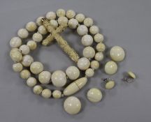 An ivory bead necklace, a carved cross and three pairs of earrings.